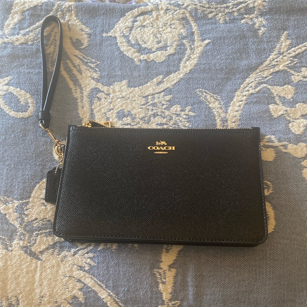 Black expandable Coach pebbled leather wristlet